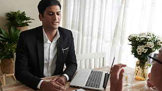 Image of man in suit having a conversation