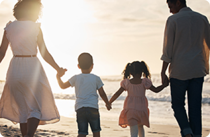 Image of family holding hands on beach
