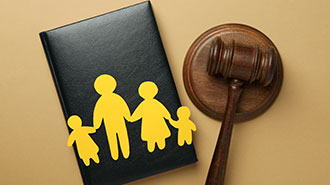 judges hammer next to paper cut outs of a family