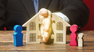 image of hands splitting up a house and family